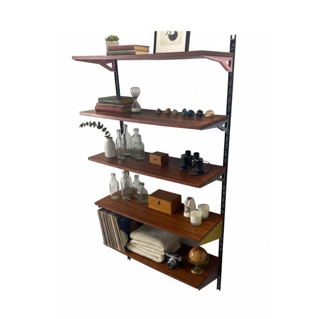 Modular bookcase from the 1960s in the Poggi or Tomado style. Five wood shelves with iconic colored metal brackets. A...