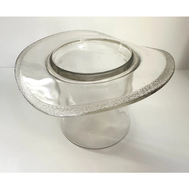 Classic and stylish glass top hat vase. Clear glass with a textured rim.