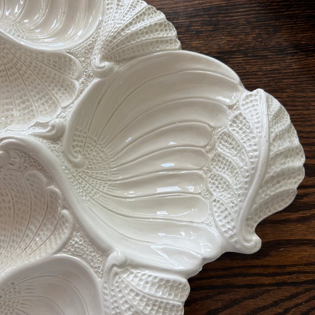 Beautiful vintage ceramic serving platter made in Italy, featuring an intricate raised seashell and coastal motif....