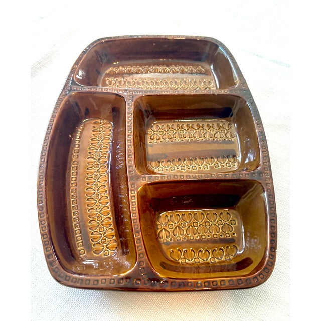 Vintage divided stoneware catchall tray featuring a rich amber-brown glaze and striking embossed geometric design. This...