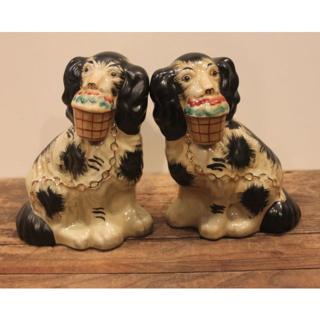 Vintage pair of Staffordshire dog figurines. Hand painted black spots and basket flowers with gilt detailing in the collar...