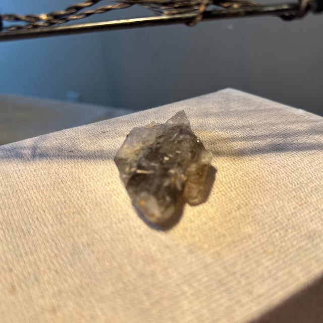 Composed of extraordinarily transparent quartz, this specimen displays crisp, well-defined faces that catch and refract...