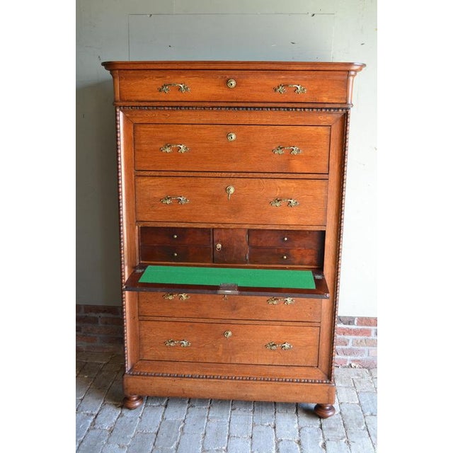 of a 19th-century Dutch oak chiffonier with a secretaire. The height is 160 cm. The width is 108 cm. The depth is 49 cm....