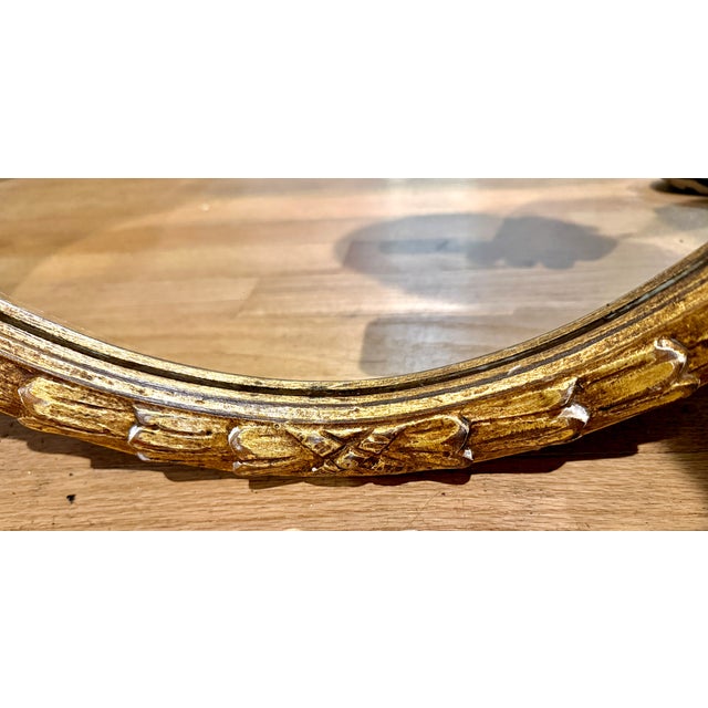 An exquisite Chelsea House Neoclassical style oval wall mirror, featuring a beautifully detailed giltwood frame. Known for...