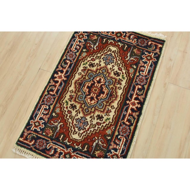 A traditional tribal Heriz rug hand-knotted with an all-wool pile on a cotton foundation. This oriental rug features a...