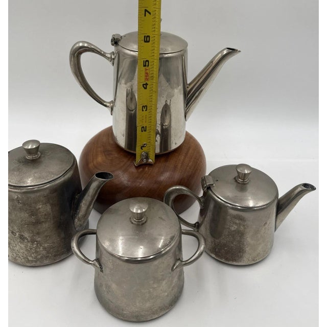 A Moroccan silver-plated tea set handmade by Berrad Maroc Abdelkrim, comprising three matching teapots and one sugar...