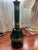 Pair of 1960’s Hollywood Regency style green glass lamps with gilt Greek key and star decorations. The bases are made of...