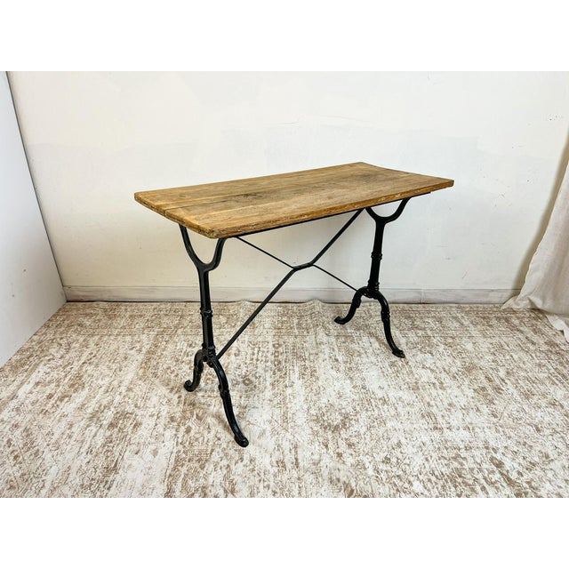 Crafted with a weathered solid oak plank top resting on an elegant cast iron base, this vintage French table reflects the...