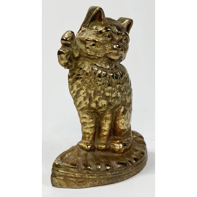 Heavy vintage cast brass doorstop featuring nicely detailed cat with ribbon bow collar atop a pillow. A solid heavy...