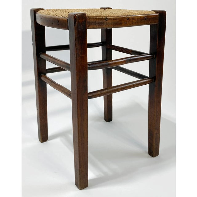 Antique English wooden four leg stool featuring rush seat. Measures 17"H. Wonderful patina. Rush seat is in great...