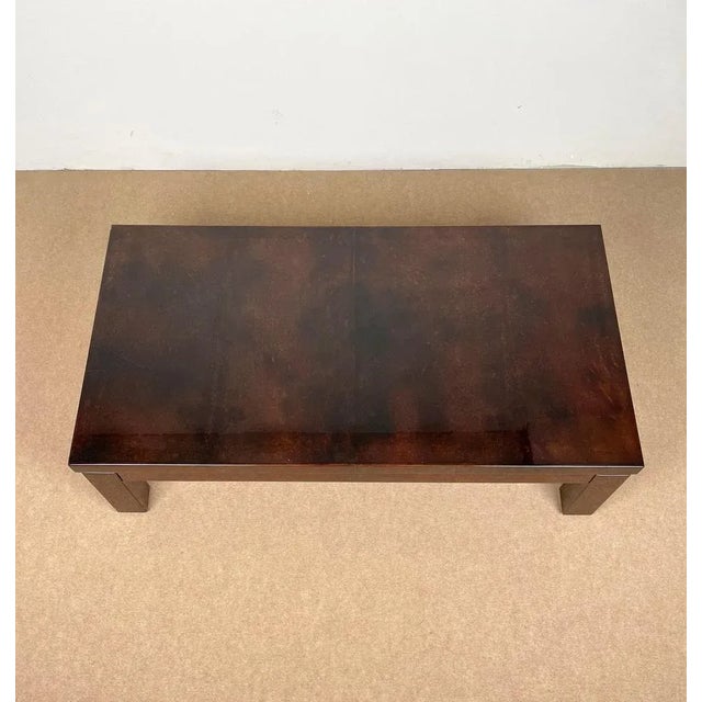Rectangular coffee table in brown goatskin with brass details attributed to the Italian designer Aldo Tura. Made in Italy...