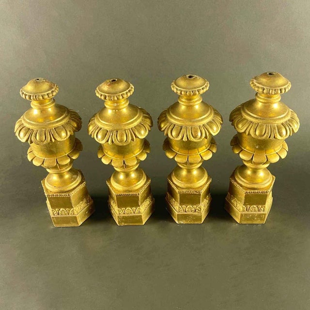 Italian Carved and Gilded Wood Finials 1800, set of four vases on a hexagonal plinth with vegetable carving frames in...