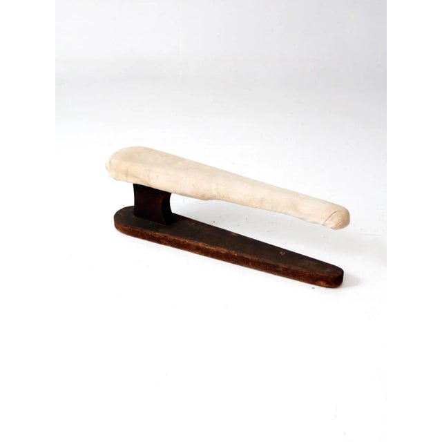 Antique tabletop ironing board, designed as a sleeve ironing board with a wooden frame and sturdy base. The piece is...