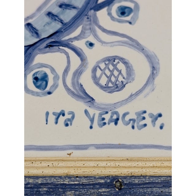 Hand-painted and signed ceramic tile by Ira Yeager featuring an anthropomorphic sun motif in cobalt blue. Glazed ceramic...