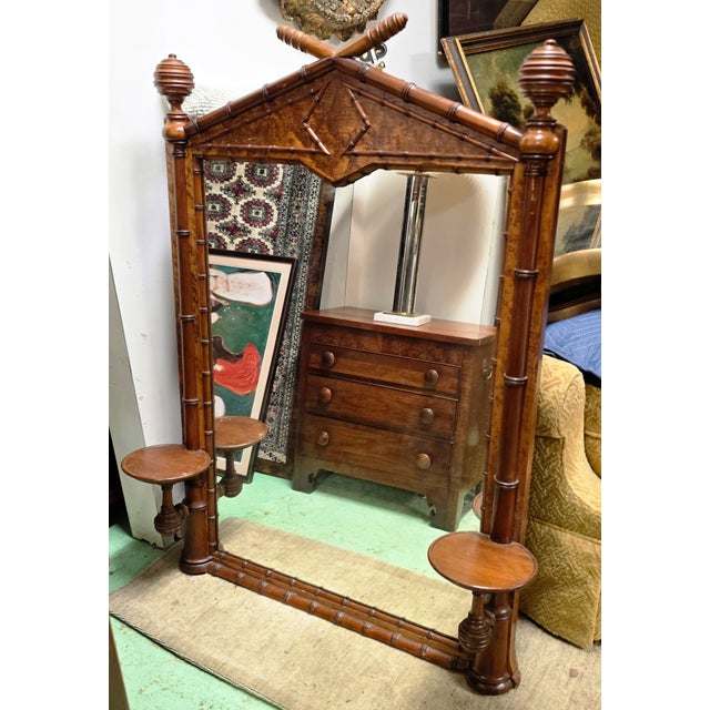 This 19th Century French Faux-Bamboo Wall Mirror, carved in richly patinated wood and designed in an architectural,...
