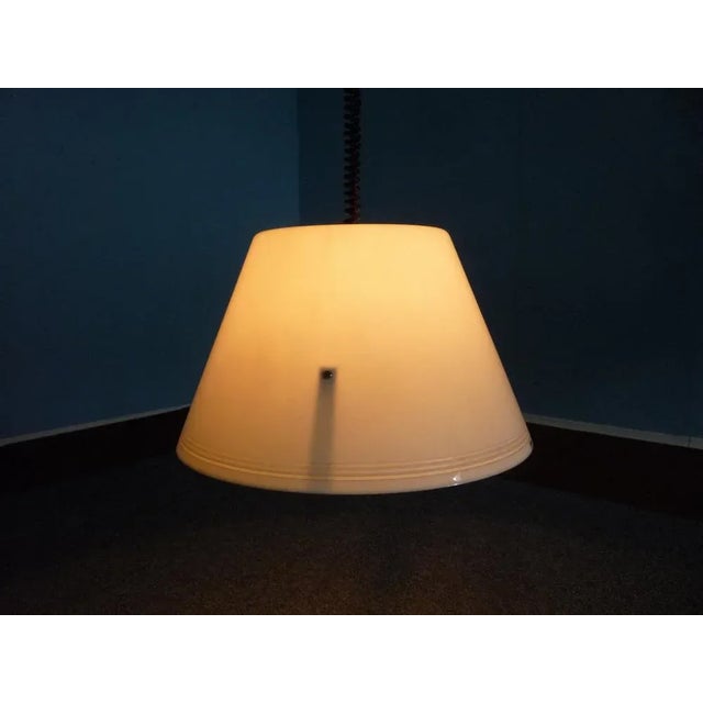 This hanging lamp was designed and produced by Guzzini in Italy. It is made from plastic and is in excellent vintage...