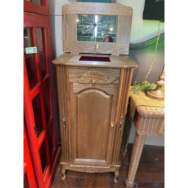This Art Deco Revival jewelry stand features quarter-sawn oak construction, stylized fan carvings, brass hardware, and a...