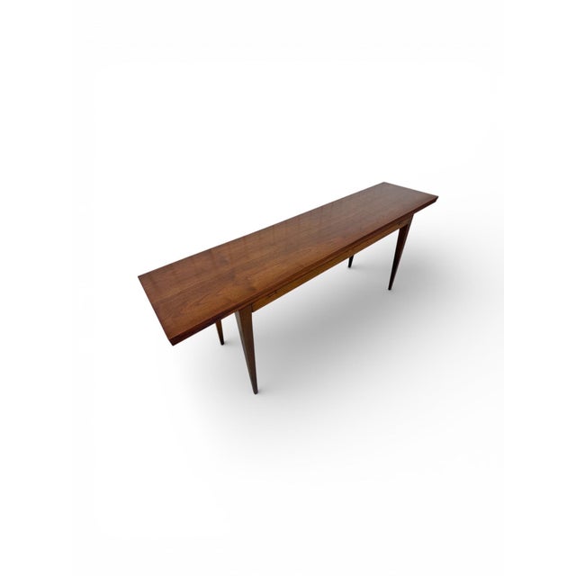This exceptional Mid-Century Modern flip-top dining table by Dunbar exemplifies refined American craftsmanship and...