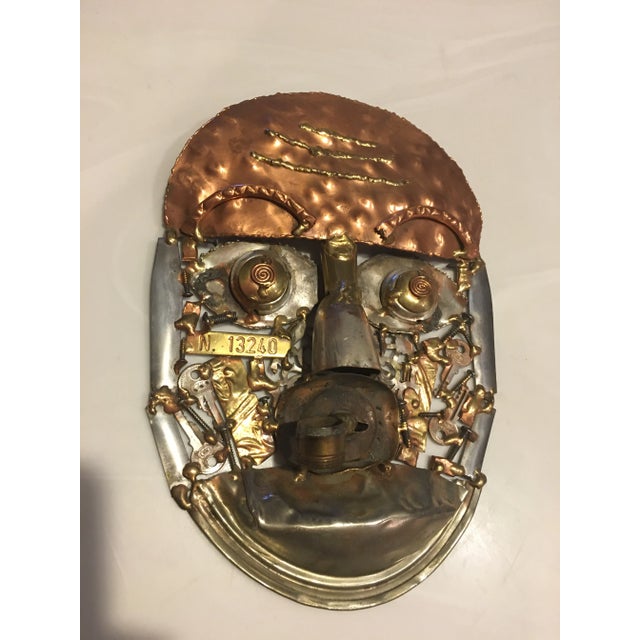 Vintage 1980’s Brutalist mixed metal mask. A unique mix of copper, brass and silver keys, screws and bolts went into this...