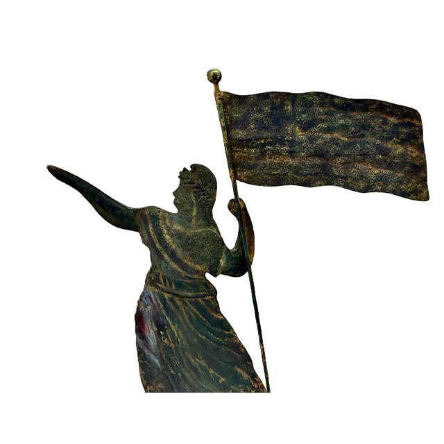 On offer is a late 19th-century American folk art "Goddess of Liberty" molded copper weathervane mounted on a gallery...
