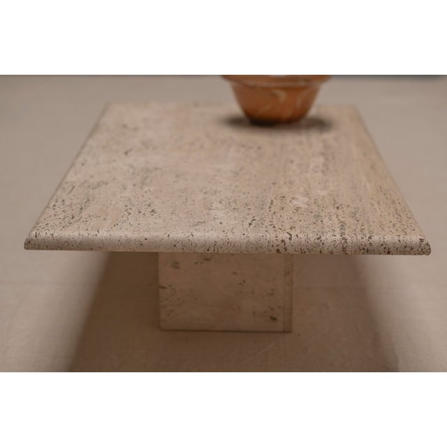 Beautifully understated rectangular travertine coffee table dating from the 1970s, distinguished by its architectural...