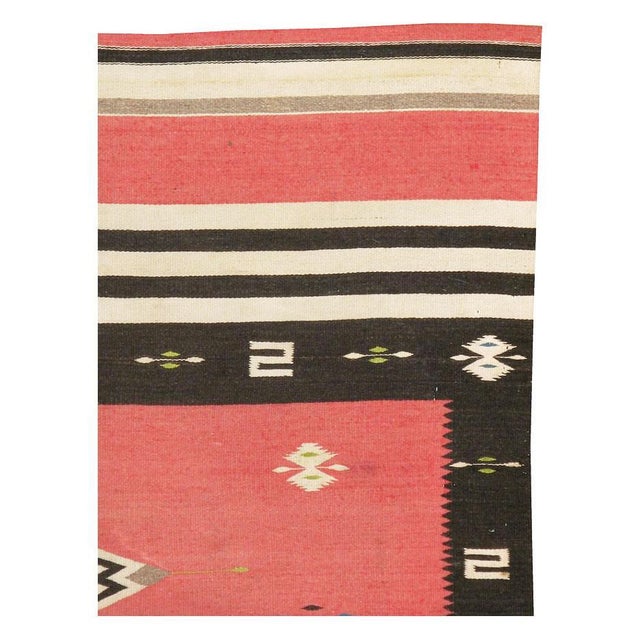 A vintage North American Navajo tribal flat-weave small accent rug in the rustic southwestern style handmade during the...