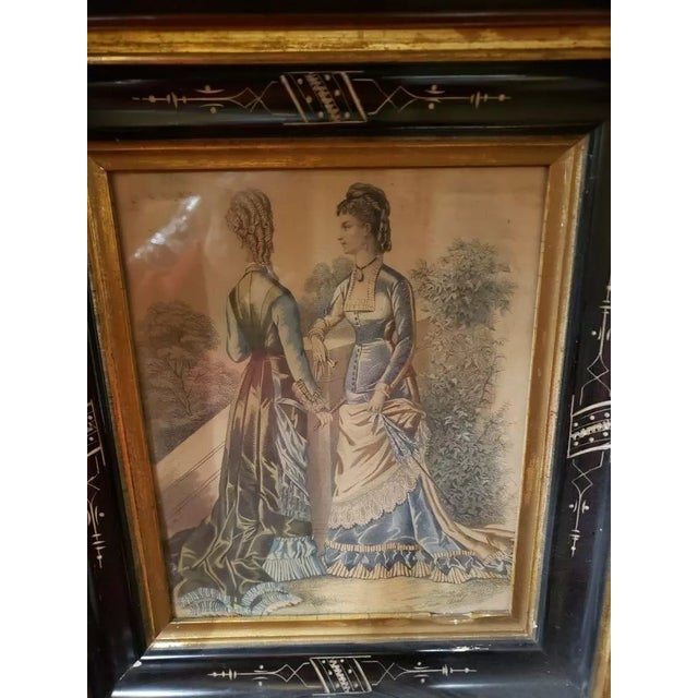 This is an Circa 1880 French Victorian Eastlake Hand Colored Fashion Print Plate Set in Walnut Ebonized Wood Frame, Laure...