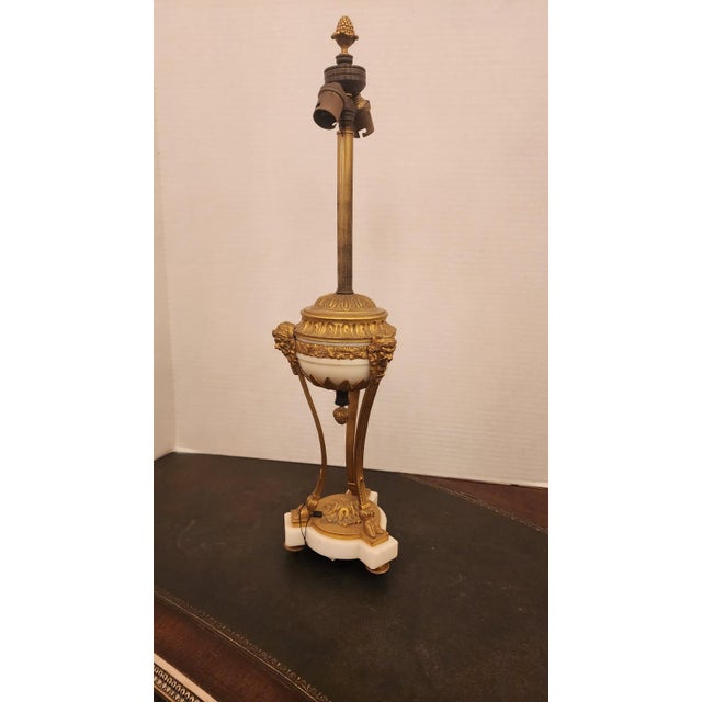 This listing features a Louis XVI style bronze gilt lamp, not wired or plugin. Comes with a lampshade that is not original...