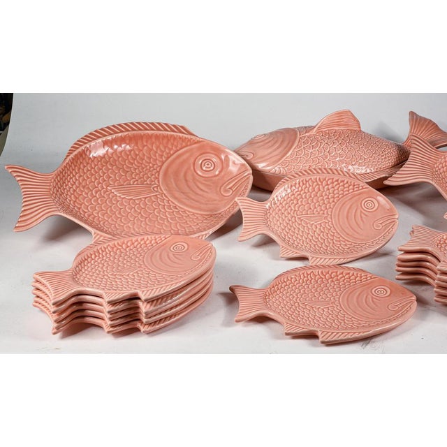 Set of plates in the shape of fish ceramic worked salmon pink marked with the writing portugal s consists of 12 small...
