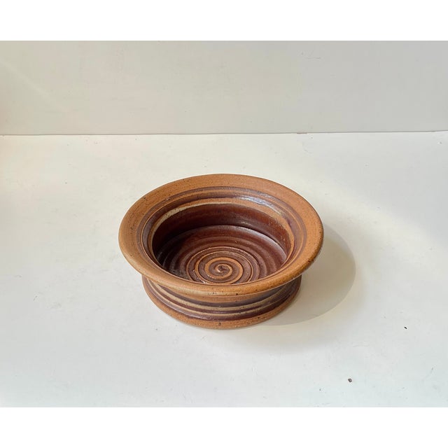 Stunning and elegant stoneware bowl or dish featuring earthy glazes in a spiraling motif. Hand-made by Tue Poulsen in his...