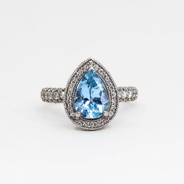 Platinum ring by "Pristine" with 1.49 carat pear shape Aquamarine and 114 round diamonds weighing 1.21 carats, 8.23g