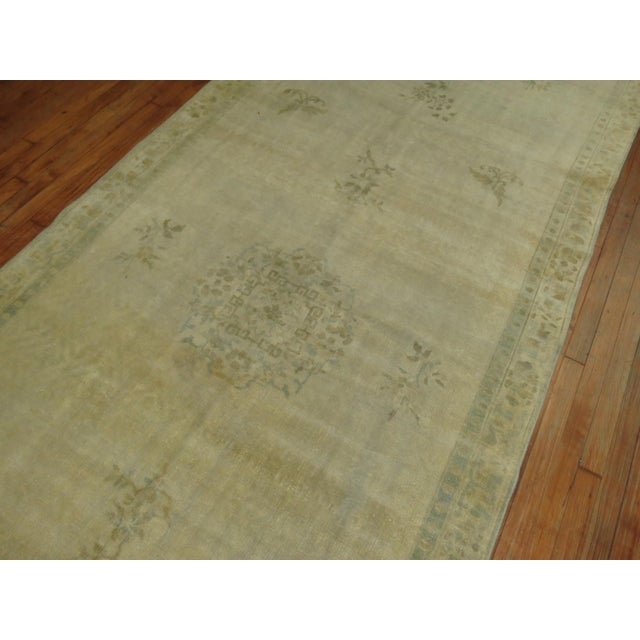 A late 19th century Long gallery size Chinese rug in beige's and green. There is some natural age related in various areas...