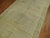 A late 19th century Long gallery size Chinese rug in beige's and green. There is some natural age related in various areas...