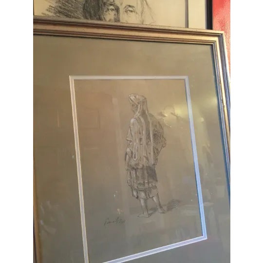A pair of sketches. Both are framed smaller frame is 20" x 16" larger frame is 20" x 16". Both pieces of art are signed by...