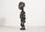 A captivating hand-carved wooden figurine representing traditional African tribal art, likely originating from the first...