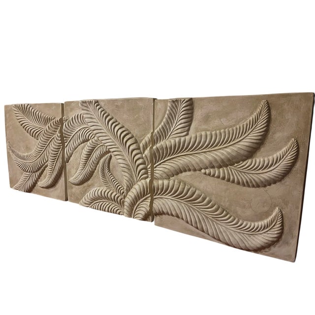 Set of three vintage botanical bas relief wall panels featuring sculptural leaf forms in a warm neutral plaster finish....