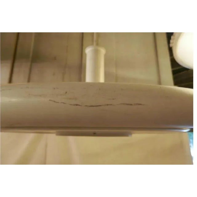 White enameled saucer style hanging lamp from Denmark. Streamlined "UFO" design by Hans Due, with center diffuser trim....