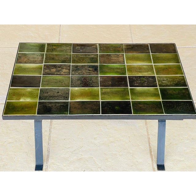 Mid- century, vintage coffee table, circa 1970s. Table top is made of rectangular, glazed ceramic tiles, with an array of...