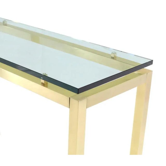 Very nice Mid-Century Modern brass base floating thick glass top console table. Perfect for a modern home.