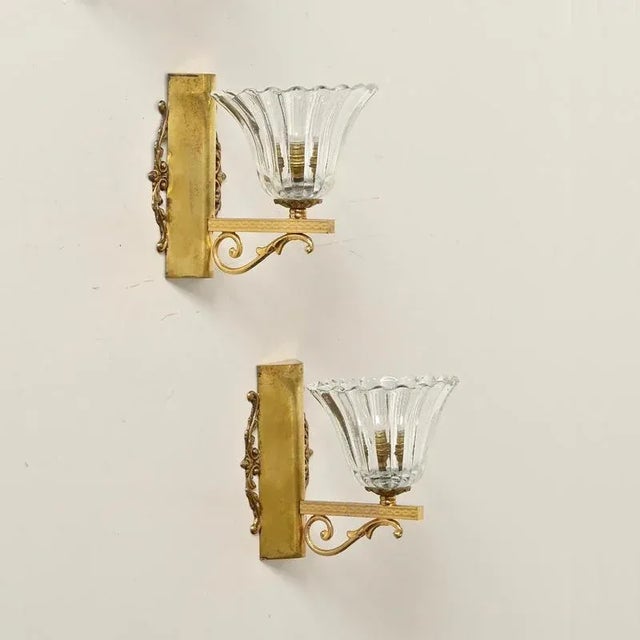 Marvelous pair of mid-century bellflower-shaped sconces in murano mouth-blown crystal glass and solid brass. These...