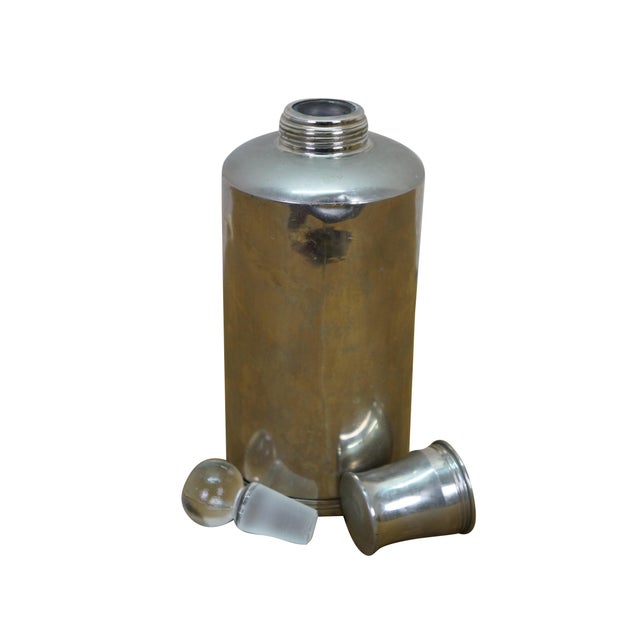 A unique early 20th Century silver plate liquor flask. Features a glass ground stopper and screw on lid / shot glass....