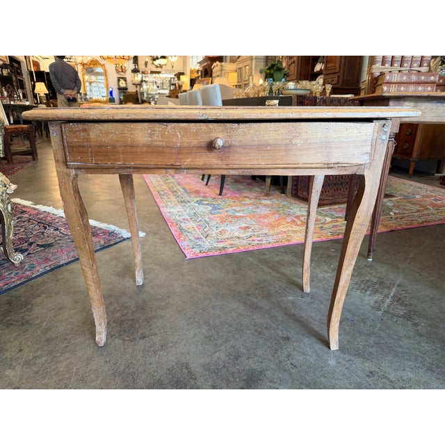 An authentic, rustic late 18th-century French Provincial fruitwood single-drawer side table or occasional writing desk....