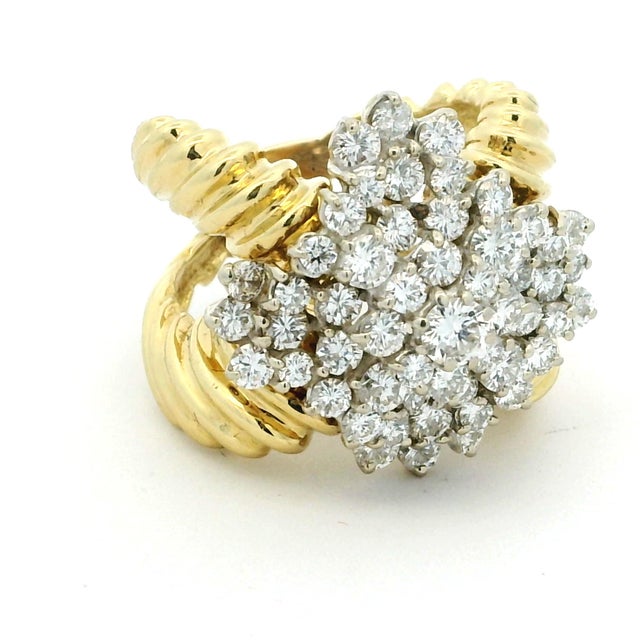 A glamorous vintage diamond cocktail ring crafted in solid 18 karat yellow gold, designed with the dramatic scale and...