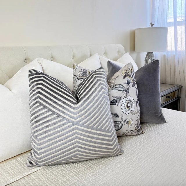 Bring a contemporary vibe to your living space with this intricate geometric pillow. The striking pattern of medium gray...