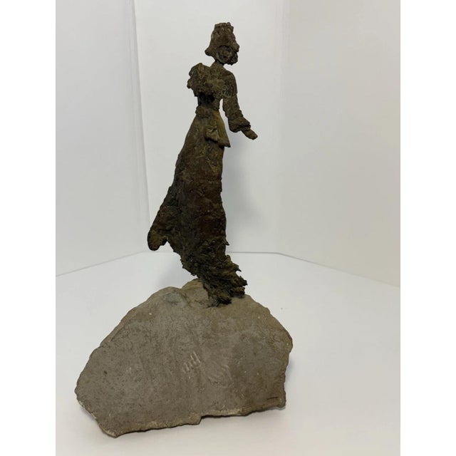 This beautiful piece depicts a female warrior in the Brutalist art style, complete with battle helmet and sash. She stands...