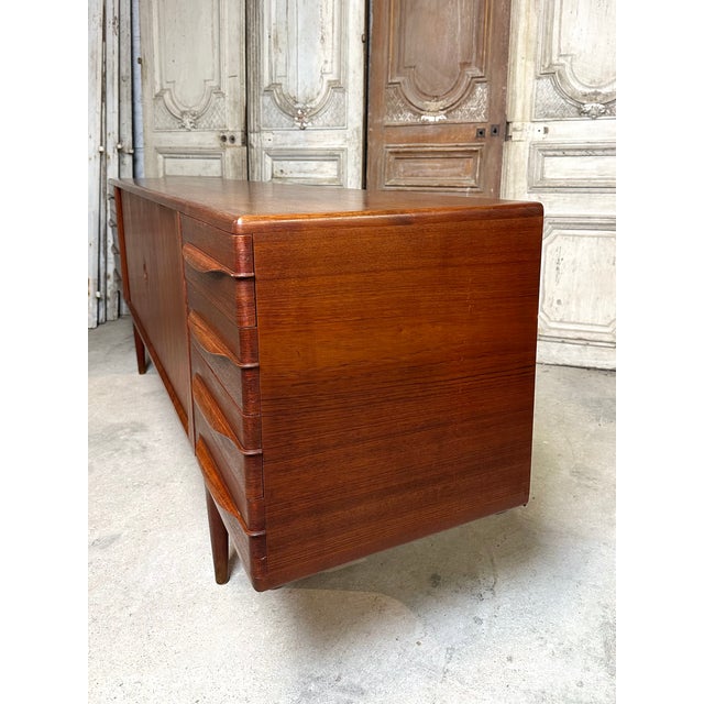 A scandinavian-style teak sideboard from the 1960s, attributed to johannes andersen. Each side features five drawers lined...