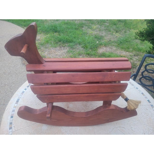 Vintage sturdy wooden toy rocking horse with a rope tail and wooden ears. Aprox. measurements. L: 28", H:24", D: 13".