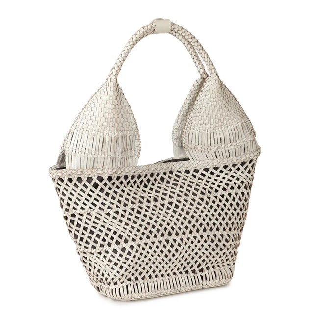 Woven white leather tote. Lined with inside zipper pocket and magnetic snap closure.