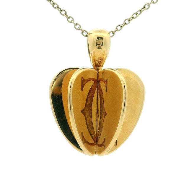 A rare and beautifully sculpted Cartier 18K yellow gold Double C 3D Apple Heart pendant, celebrating love and timeless...