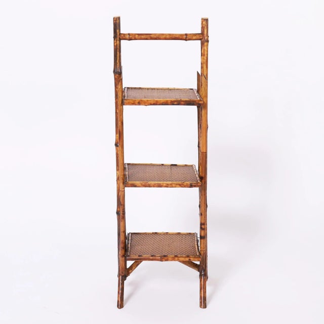 Standout 19th century English stand handcrafted in bamboo with a burnt bamboo faux tortoise finish having three tiers...
